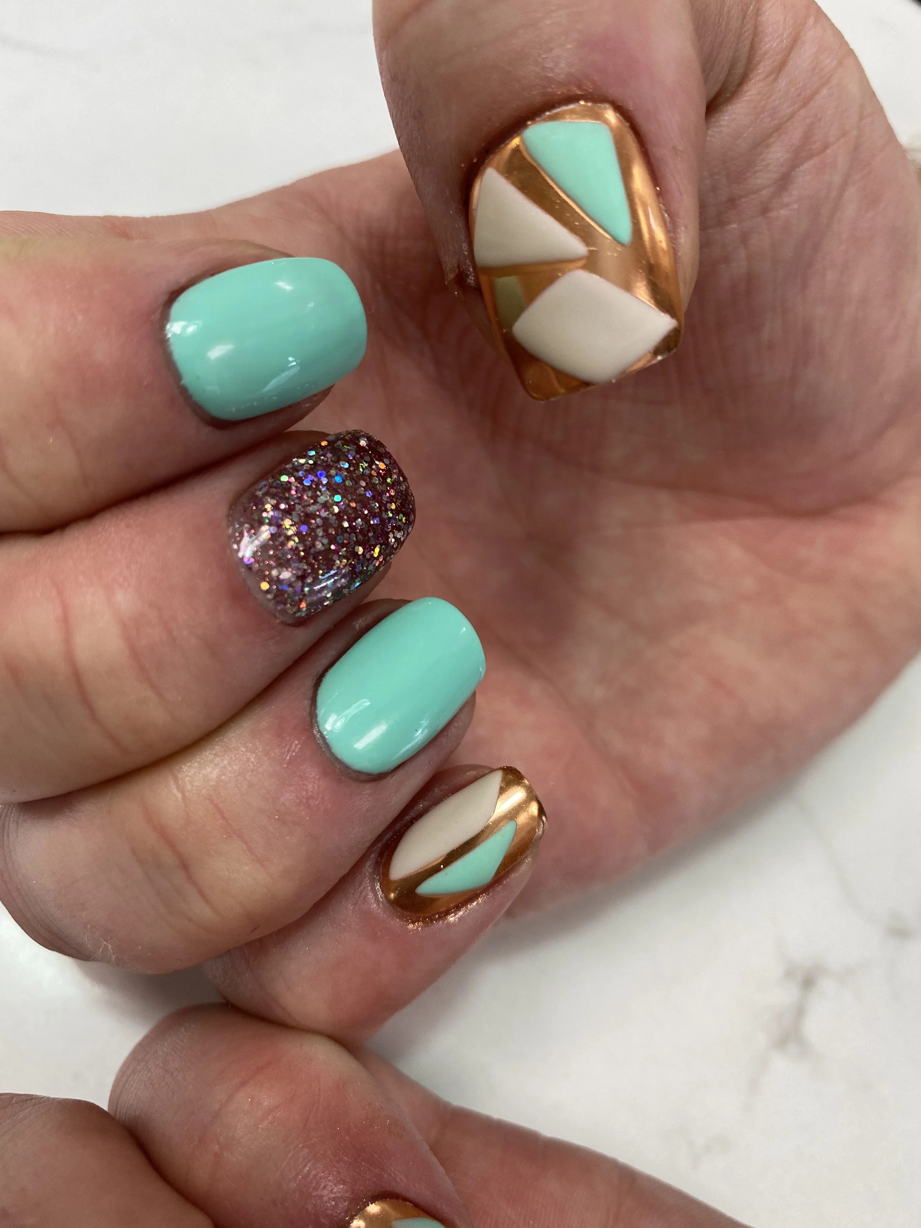 Short square nails — mint, copper-chrome geometric colour-block with holographic glitter accent