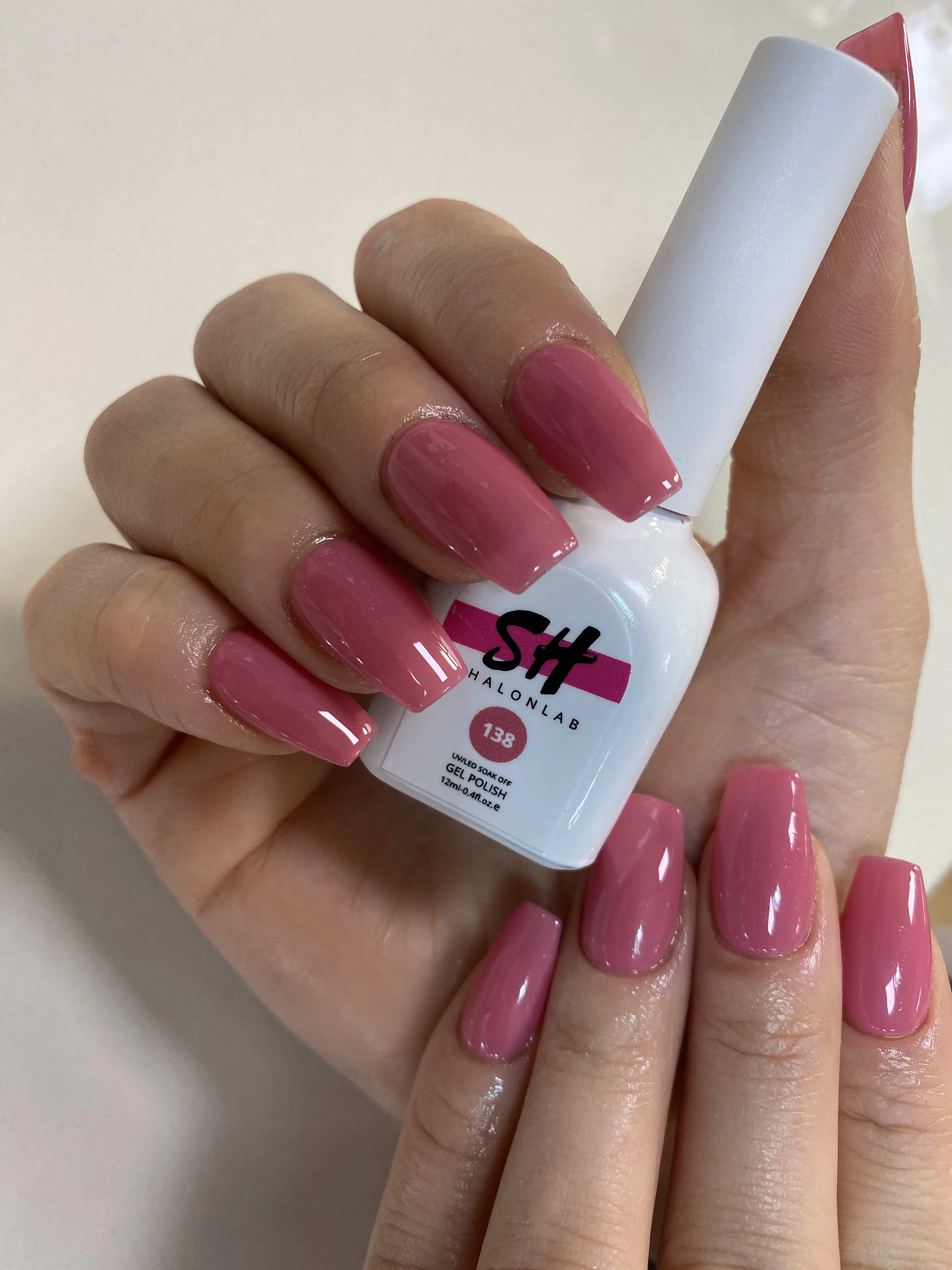 Rose and mauve long coffin nails beside a Shalonlab gel-polish bottle